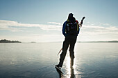 Man ice-skating on frozen lake