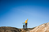 Woman and girl standing on rocks