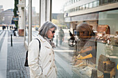 Woman looking in shop window