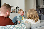 Parents with baby on sofa