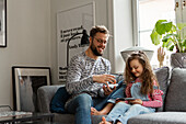 Father and daughter looking at pictures