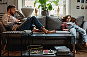 Father and daughter on sofa