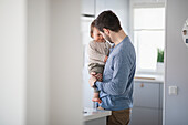 Father with baby in kitchen