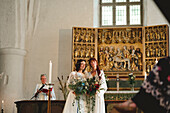 Brides at wedding ceremony