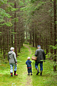 Grandparents with grandson in forest
