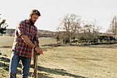 Woman repairing fence