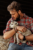 Farmer holding lamb