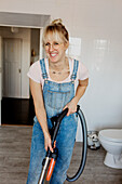 Smiling woman with vacuum cleaner