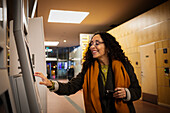 Woman buying tickets in ticket machine