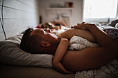 Father and child sleeping in bed