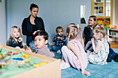 Teachers with children in playschool