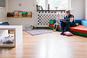 Teacher reading to girl in playschool