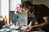 Father with baby at home