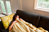 Woman sleeping on sofa