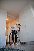 Woman hoovering apartment