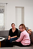 Mother with daughters on sofa