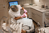 Dentist examining patients teeth