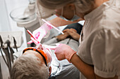 Dentist examining patients teeth