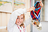 Girl holding medals