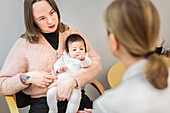 Mother with baby in doctor's office