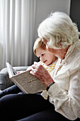 Grandmother reading book to grandson