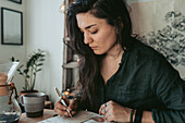 Woman making notes in diary