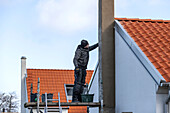 Man plastering chimney