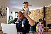 Man with children using laptop