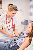 Female doctor examining girl