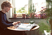 Man using laptop at home