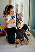 Mother with sons taking selfie