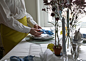 Mid section of woman preparing Easter place setting