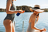 Female friends relaxing on jetty