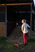 Woman raking hay