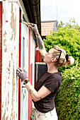 Woman painting house