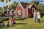 Family playing croquet in garden