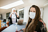 Woman in office wearing face mask