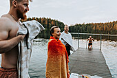 Smiling friends at lake