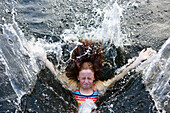 Girl splashing into sea