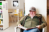 Senior man reading in library