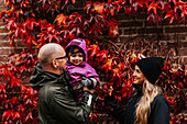 Parents standing with toddler daughter