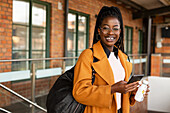 Smiling woman at train station