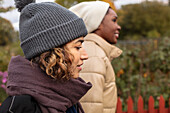 Two young women walking in park