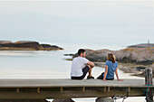 Couple sitting on jetty