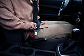 Woman fastening seatbelt