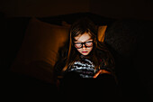 Girl using electronic device at night
