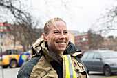 Smiling female firefighter looking away