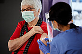 Senior woman getting covid vaccine