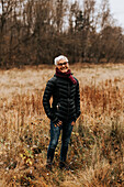 Smiling woman on meadow looking at camera