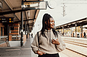 Young woman waiting at train station